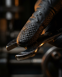 Close-up of gloved hand gripping a wrench